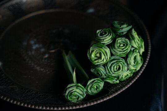 Green flowers that are folded using pandan leaves to worship the gods according to belief.Close up of Pandan Leaf Roses by Thai handicraft , using fresh pandan leaves which are folded into the shape o