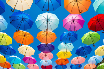 Colorful open umbrellas above the street. Concept of creativity, beauty, happiness.