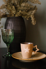 Cup of tea in a winter mug on the bedside table