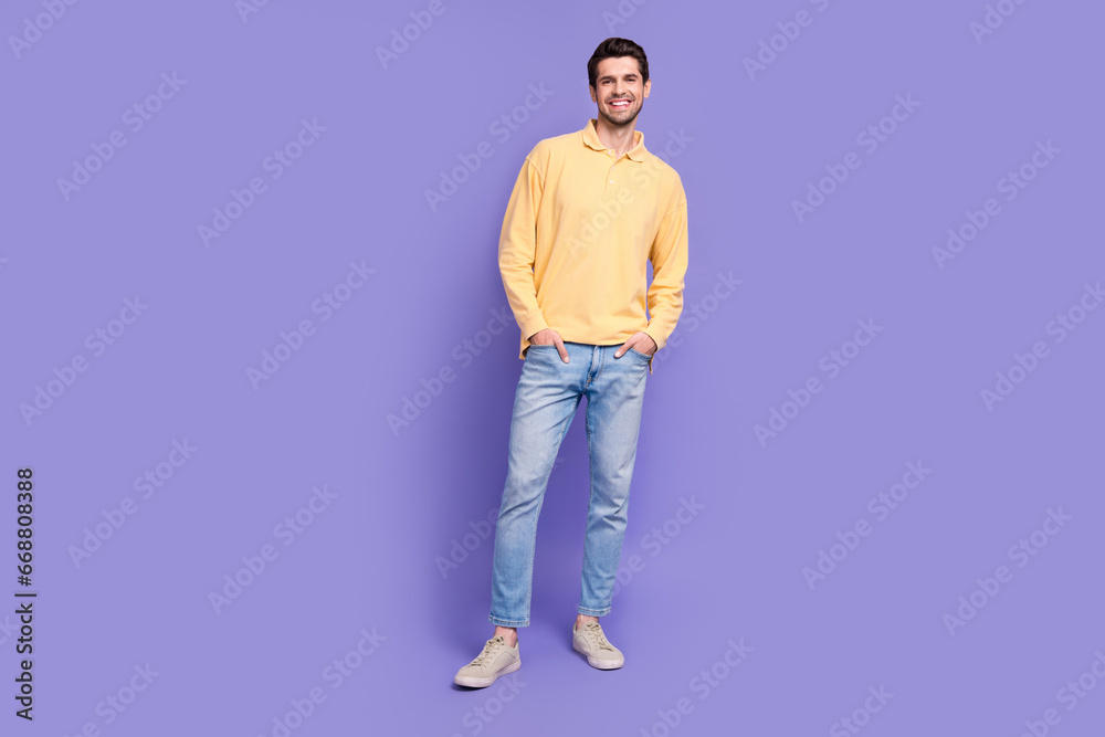 Poster full size portrait of satisfied cheerful person good mood put hands pockets posing isolated on purpl