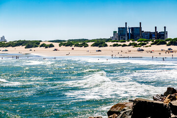 Necochea city, Buenos Aires, Argentina. View of the town skyline and the beach from the harbor pier. - obrazy, fototapety, plakaty