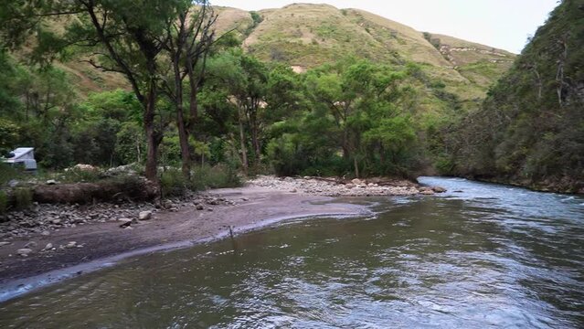 small lively river flowing through a gorge in the andes on the way towards the historical archeological site of the tombs of Revash.