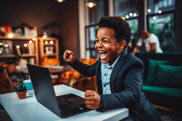 Beautiful young black man smiling and rejoicing after success. Happy man celebrating business success on sofa in living room with computer. - obrazy, fototapety, plakaty