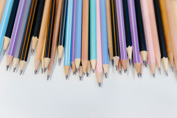 Many wooden pencils on a white background