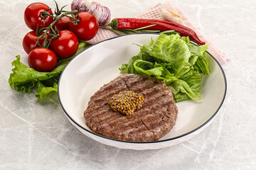 Frilled beef burger cutlet with iceberg