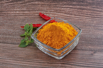 Yellow vibrant curcuma powder in the bowl