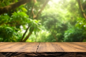 Blurred tropical nature background with green lush foliage vegetation jungle plants palm tree leaves with empty plank wood table in the forefront for product placement presentation - obrazy, fototapety, plakaty