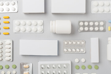 Flat lay with different pills in blister packaging and boxes and on color background - obrazy, fototapety, plakaty