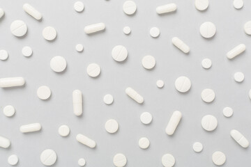 Flat lay with different medical pills and capsules on color background