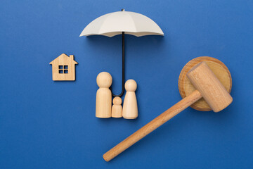 Wooden family figures with judge's gavel on color background,top view