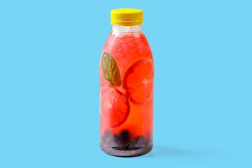 Bubble gum lemonade with currants, lime, mint, bubble gum syrup, ice, soda water on blue background...