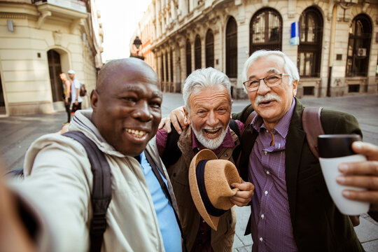 Portrait of elderly men taking a selfie on vacation in the city