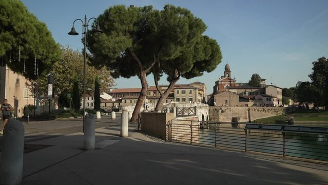 View of Ponte di Tiberio and local restaurant and cafe, Rimini, Emilia Romagna, Italy
