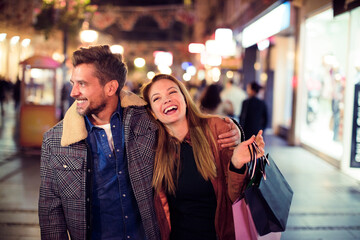 Young couple enjoying a shopping evening in the city