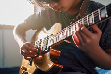 Child playing electric guitar at home - obrazy, fototapety, plakaty