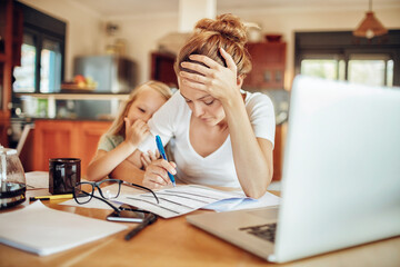 Happy young girl comforting her mother during a financial crisis at home - obrazy, fototapety, plakaty