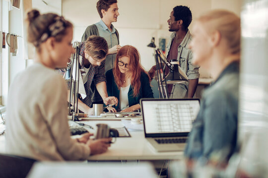 Young and diverse group of architects working on a project together in a startup company office
