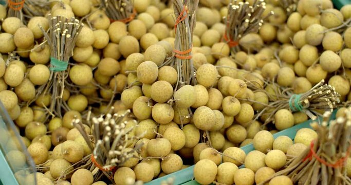 Longan sold in the super market in Thailand.Many yellow longan.Fresh longan for sale at the market.Vegetable shop with fresh vegetables.