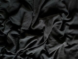 Black fabric texture background. Embroidery fabric texture background. Black canvas with folds as...