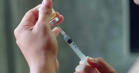 Using syringe suck out of bottle by turning the medicine bottle upside down and slowly pulling the medicine out of the bottle.Syringe with liquid being drawn into syringe. - Powered by Adobe