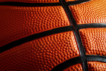 Fototapeta premium Macro view of textured leather basketball surface. Streetball and hoops. Sports patterns and backgrounds. Shadows and highlights