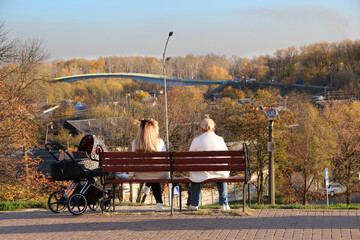 Family of three people Grandma, mother and child in stroller. 3rd generation