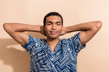 Photo portrait of handsome young guy sleeping hands behind head dressed stylish blue print outfit...