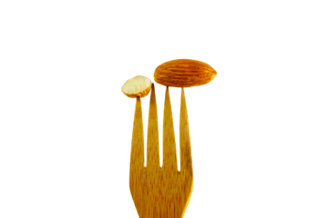 almond dry fruit hold on wooden fork flying isolated cutout in transparent background,png format