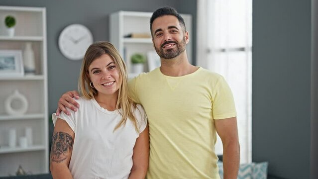 Man and woman couple hugging each other standing at home