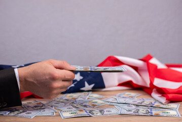 Flag of America USA. Money dollars on the background. A symbol of economic power in the...