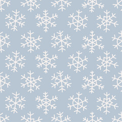 Seamless pattern with hand drawn snowflakes on blue background. Good for Christmas wallpapers, textile, gift wrap paper. Vector.