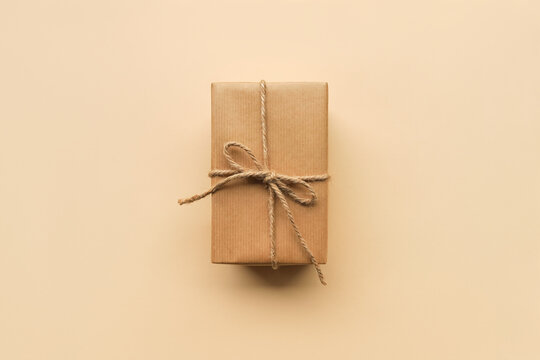 gift box packed in craft brown paper, top view, flat lay. Christmas and New Year gifts, gift wrapping concept