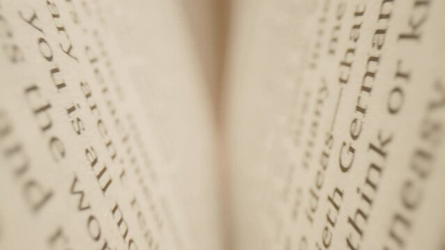 Macro Camera Moving Inside the Books. Close up of English texts on book sheets. Macro shot moves between book pages.