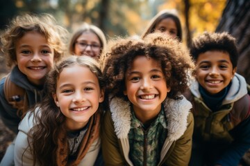 Children of different nationalities enjoy autumn, play, run, laugh and smile in an autumn park with yellow leaves