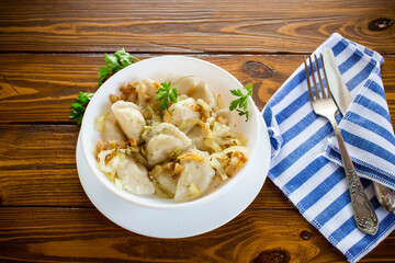 Ukrainian Vareniky or Pierogi stuffed with potato and mushrooms, served with fried onion.