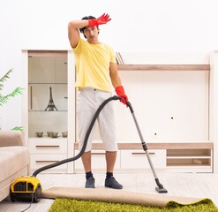 Young handsome man doing housework