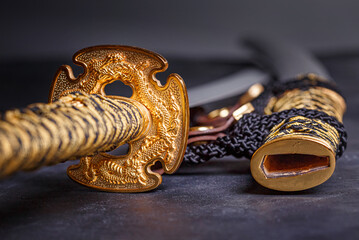 Japanese samurai katana sword and scabbard close up. Photo of a weapon in low key with selective focus