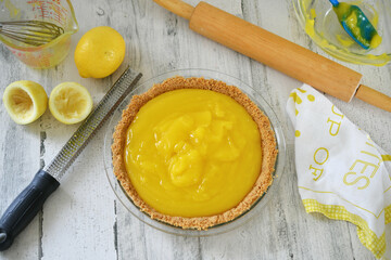 Homemade lemon pie filling in a graham cracker crust for a lemon meringue pie yellow kitchen