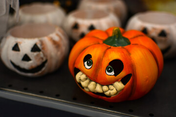 Creative dark Halloween backdrop with DIY ceramic pumpkins.