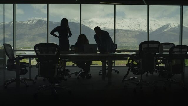 Silhouette of business people talking in conference room with scenic view / Pleasant Grove, Utah, United States