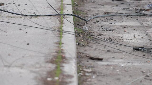 Bare wires lying on the ground. Chernigov. The war in Ukraine.