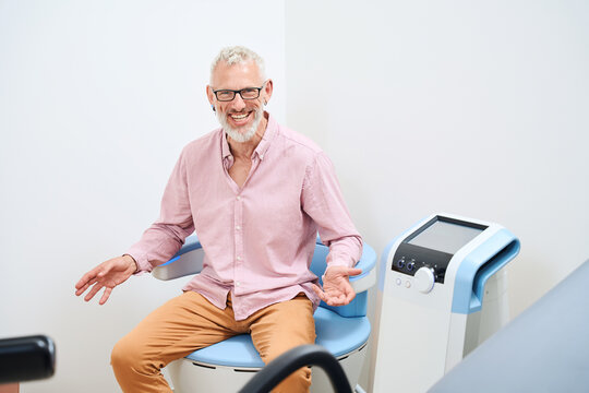Mature man undergoing physiotherapy procedure to stimulate pelvic floor muscles