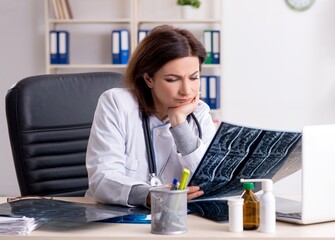 Aged female doctor working in the clinic