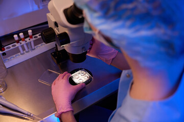 Lab researcher is performing micropipette cell aspiration for storage