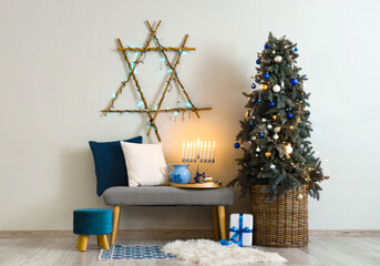 Interior of living room decorated for Hannukah with soft bench and fir tree