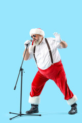 Cool Santa Claus with microphone singing Christmas song on blue background