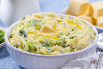 Traditional homemade Irish dish Colcannon or mashed potato with green cabbage and butter, horizontal