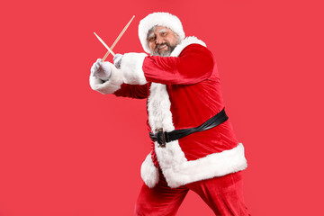 Cool Santa Claus with drumsticks on red background