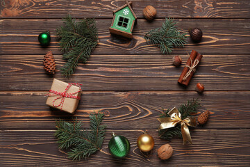 Beautiful fir branches with Christmas decorations and gift boxes on brown wooden background