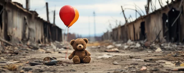 Foto op Canvas kids teddy bear toy with balloons over city burned destruction of an aftermath war conflict, earthquake or fire and smoke of world war against children peace innocence as copyspace banner © sizsus